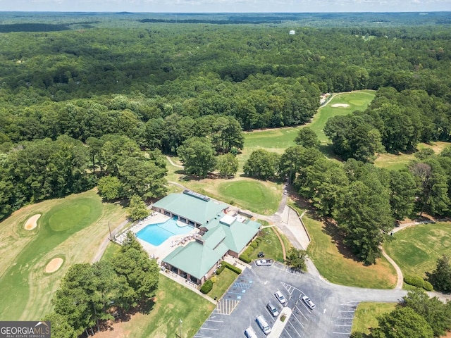 birds eye view of property with a forest view and golf course view