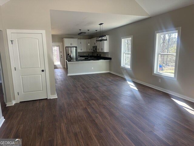 unfurnished bedroom featuring ceiling fan, dark wood-type flooring, and a closet