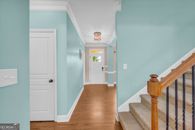 foyer featuring hardwood / wood-style flooring and ornamental molding