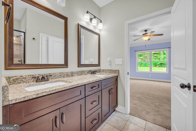 bathroom with ceiling fan, tile patterned flooring, vanity, and a shower with door