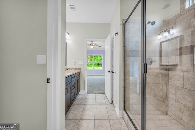 bathroom with vanity, tile patterned floors, ceiling fan, and a shower with shower door