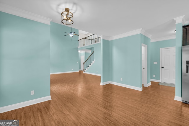 empty room with hardwood / wood-style floors, ceiling fan, and crown molding