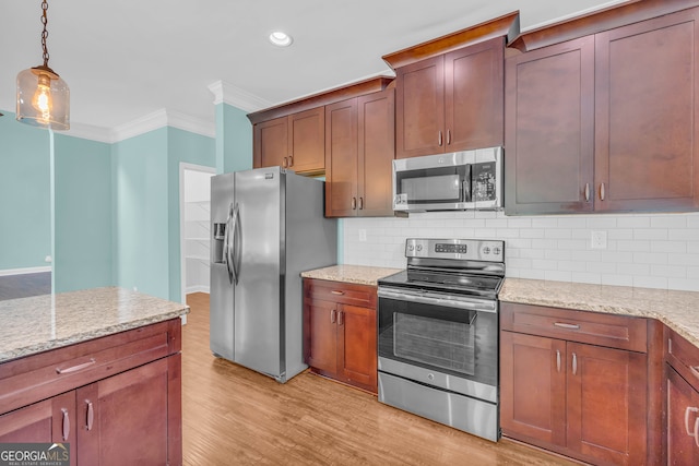 kitchen with decorative light fixtures, light stone countertops, stainless steel appliances, and tasteful backsplash