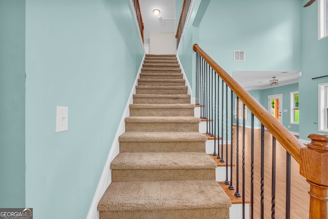 staircase with a towering ceiling