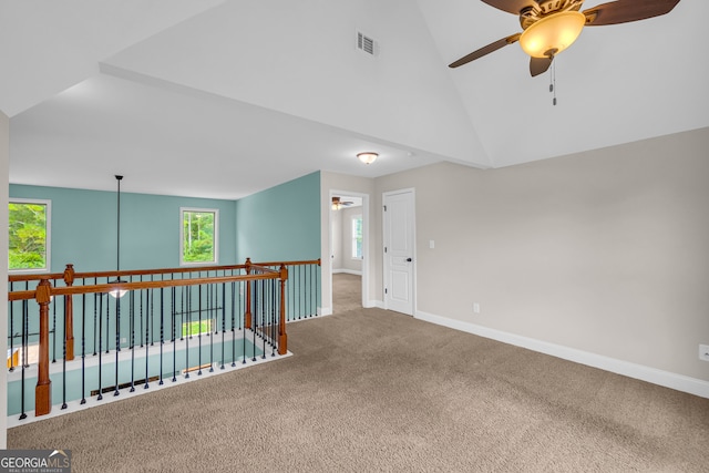 carpeted empty room featuring high vaulted ceiling and ceiling fan