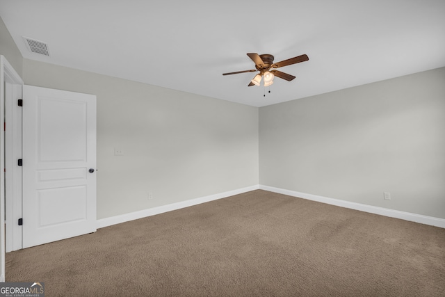 spare room featuring ceiling fan and carpet