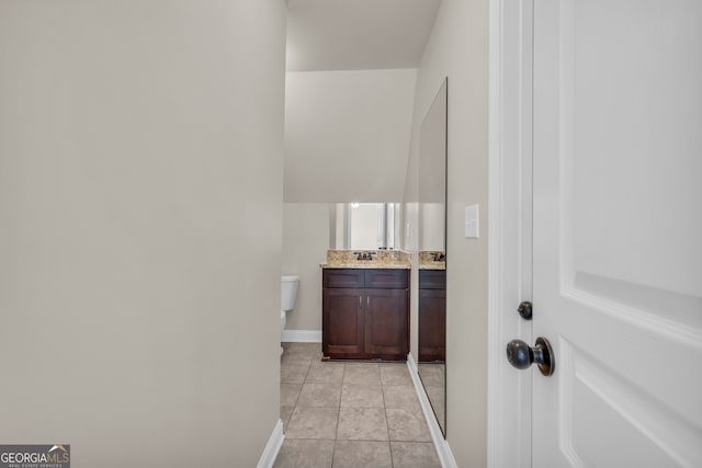 corridor with light tile patterned floors and sink