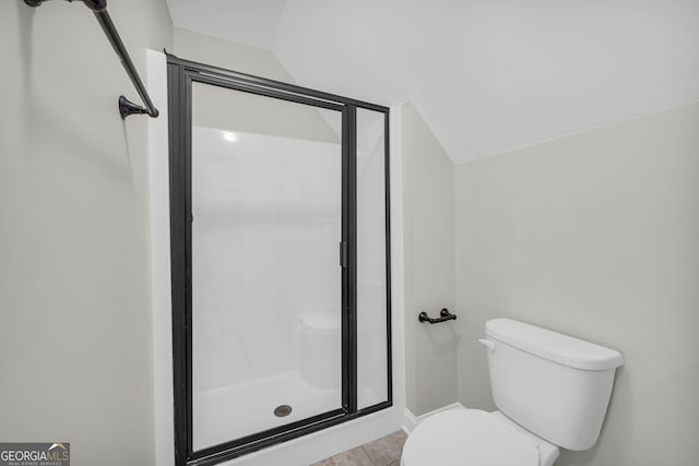 bathroom featuring walk in shower, tile patterned flooring, lofted ceiling, and toilet