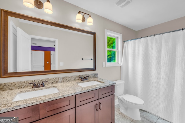 bathroom featuring tile patterned flooring, vanity, and toilet