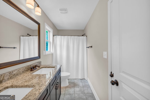 bathroom with tile patterned flooring, vanity, and toilet