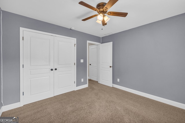 unfurnished bedroom featuring carpet floors, a closet, and ceiling fan