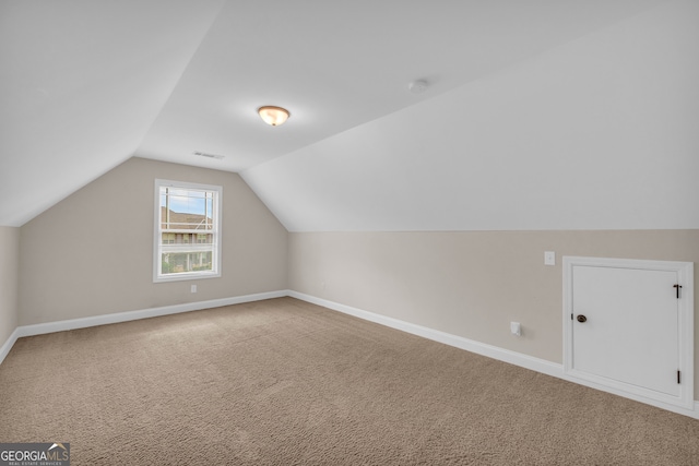 bonus room featuring carpet and vaulted ceiling