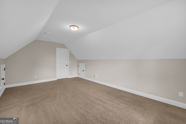 bonus room featuring carpet flooring and vaulted ceiling