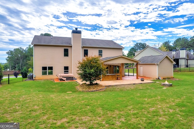 rear view of house with a yard and a patio area