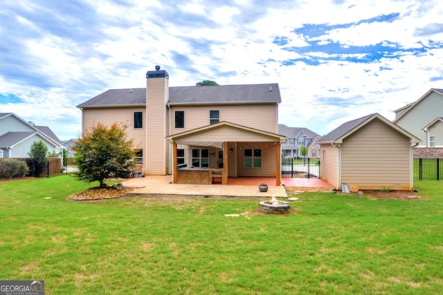 back of property with a patio area and a yard