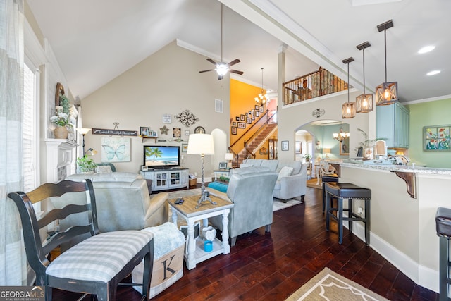 living room with high vaulted ceiling, dark hardwood / wood-style floors, ceiling fan with notable chandelier, and ornamental molding