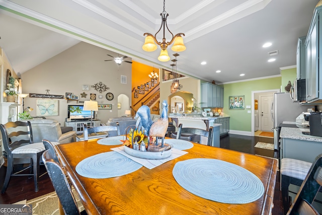 dining room featuring ceiling fan with notable chandelier, dark wood-type flooring, and ornamental molding