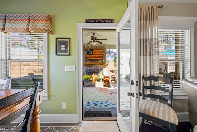 doorway to outside with ceiling fan