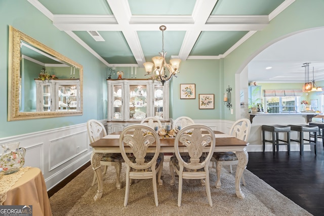 dining room with beamed ceiling, a notable chandelier, crown molding, and coffered ceiling