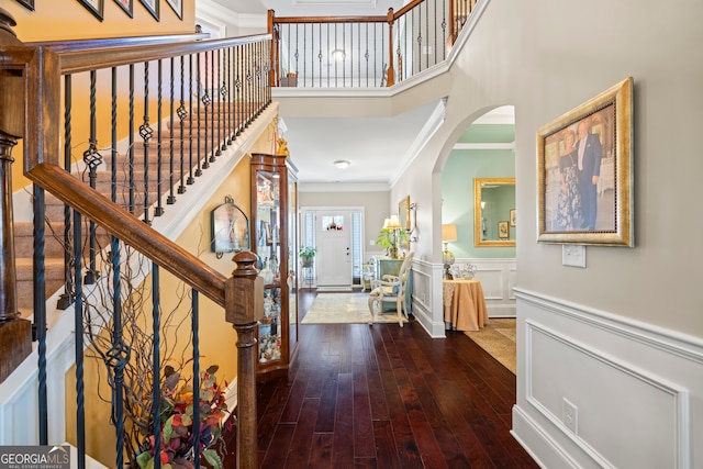 entryway featuring wood-type flooring and crown molding