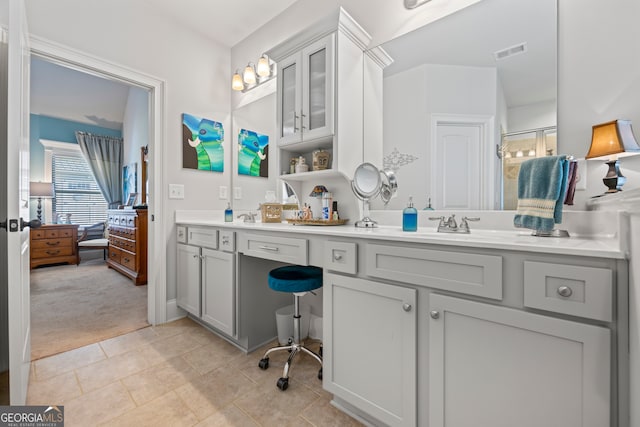 bathroom with vanity, tile patterned floors, and walk in shower