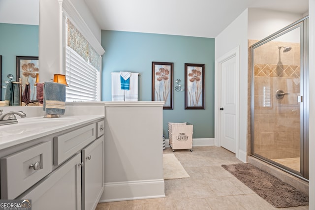 bathroom featuring a shower with door and vanity