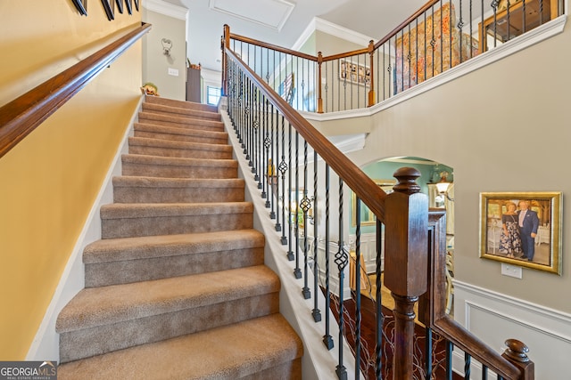 stairs featuring crown molding