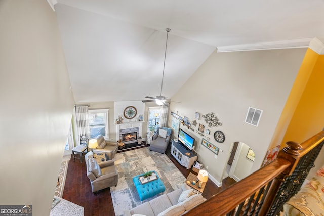 living room with dark hardwood / wood-style floors, ceiling fan, and high vaulted ceiling