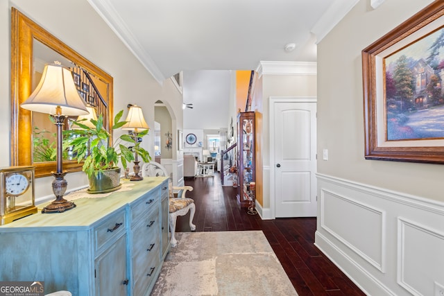 hallway with dark hardwood / wood-style flooring and crown molding