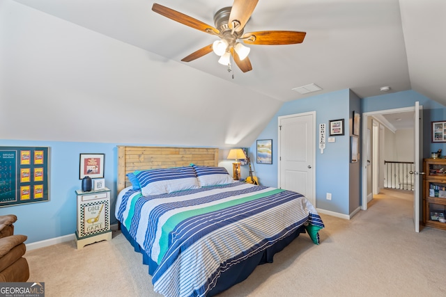 carpeted bedroom with vaulted ceiling and ceiling fan