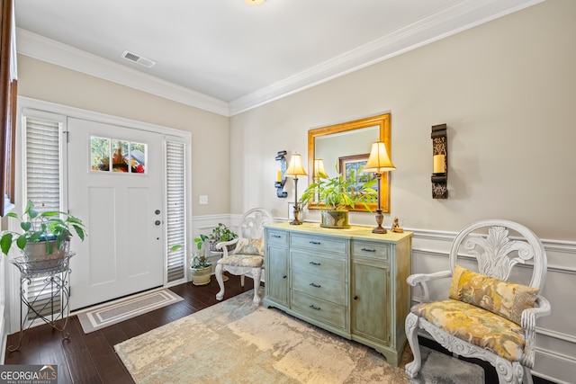 entrance foyer with dark hardwood / wood-style flooring and crown molding