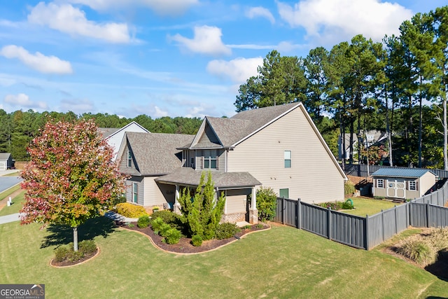 view of home's exterior featuring a lawn and a shed