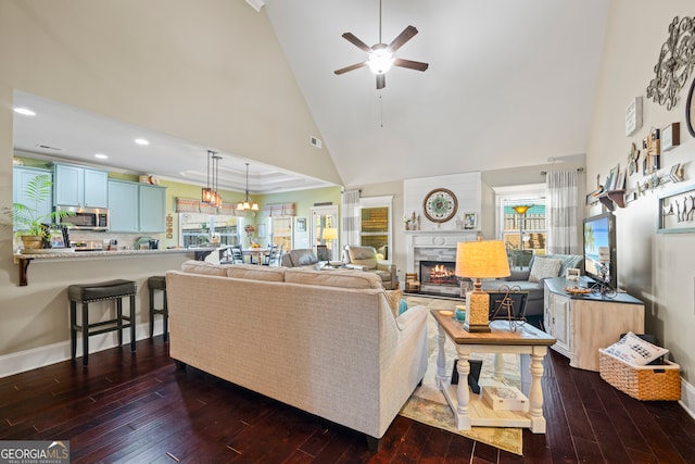 living room with a tile fireplace, ceiling fan, high vaulted ceiling, and dark wood-type flooring