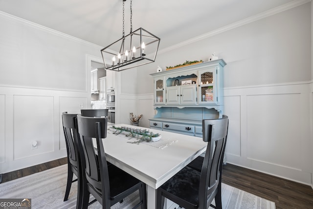 dining area with ornamental molding, dark wood-type flooring, and a notable chandelier