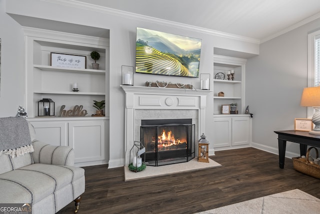 living room with dark hardwood / wood-style floors, built in features, and ornamental molding