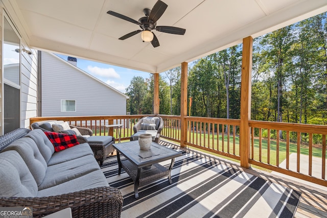 wooden terrace with ceiling fan and an outdoor hangout area