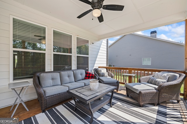 wooden deck featuring outdoor lounge area and ceiling fan