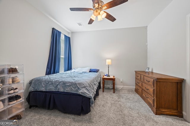 bedroom featuring ceiling fan and light carpet