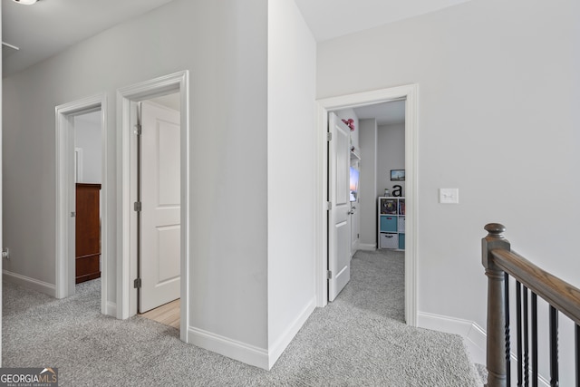 corridor with light colored carpet