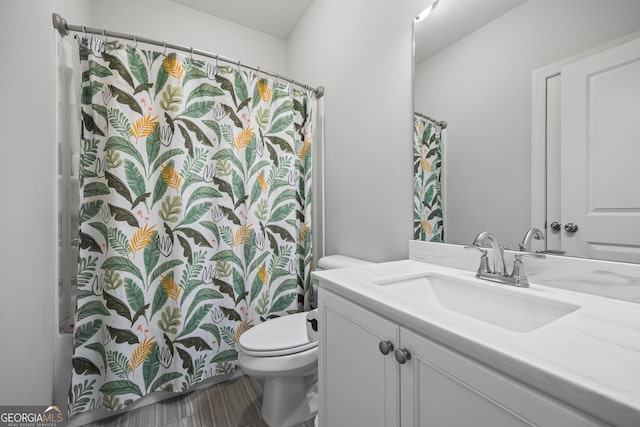 bathroom featuring vanity and toilet