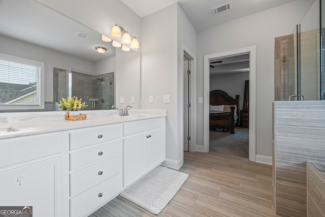 bathroom with vanity and a shower with shower door