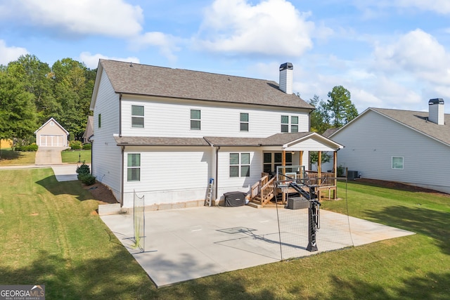 back of property featuring a patio area, a yard, and a wooden deck