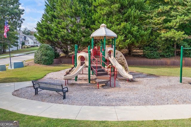 view of playground with a lawn