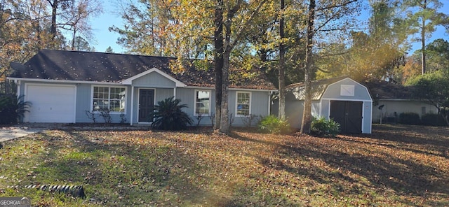 ranch-style home with a garage and a storage shed