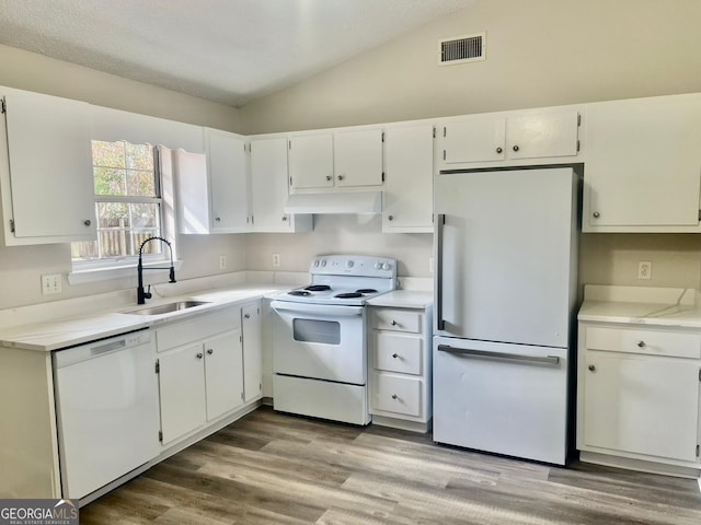 kitchen with vaulted ceiling, light hardwood / wood-style floors, sink, white appliances, and white cabinets