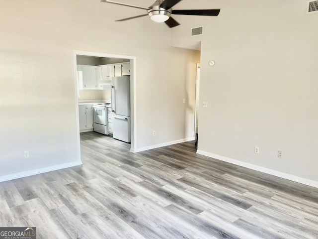 unfurnished living room with ceiling fan and light hardwood / wood-style floors