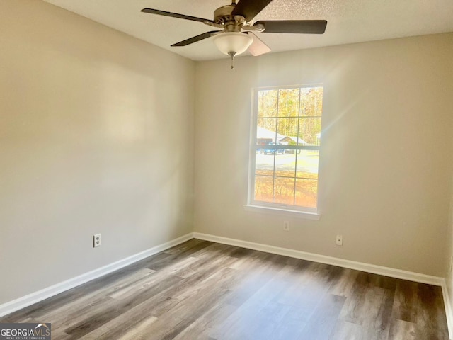 unfurnished room featuring ceiling fan and hardwood / wood-style floors