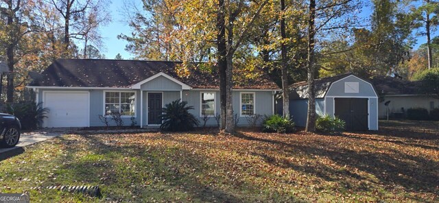 single story home with a garage and a storage unit