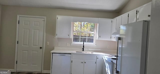 kitchen with custom exhaust hood, sink, white appliances, white cabinetry, and hardwood / wood-style flooring