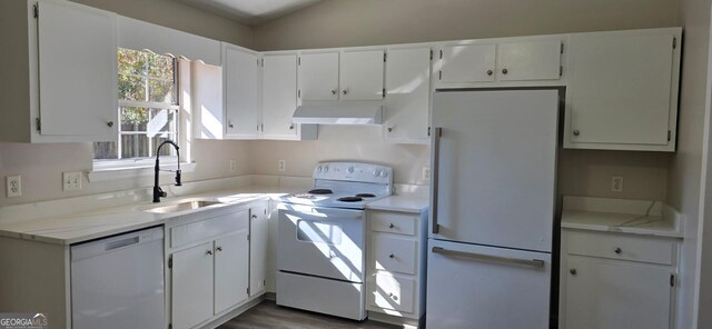 kitchen with white appliances, lofted ceiling, dark wood-type flooring, white cabinetry, and sink